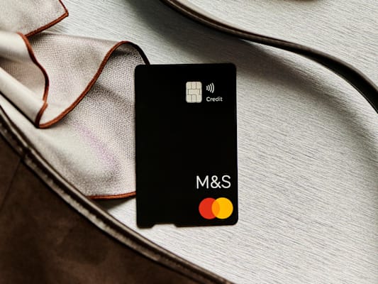 Hand holding an M&S credit card