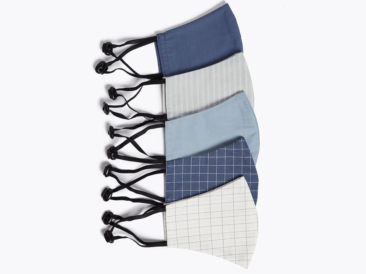 A selection of blue and grey striped, checked and plain face coverings