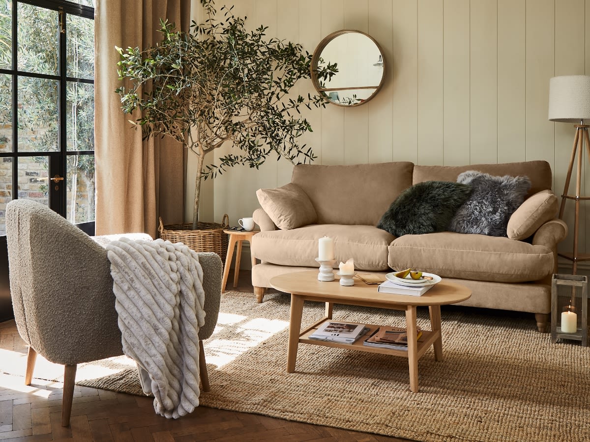 Living room with modern comfy sofa and armchair. Shop all furniture offers