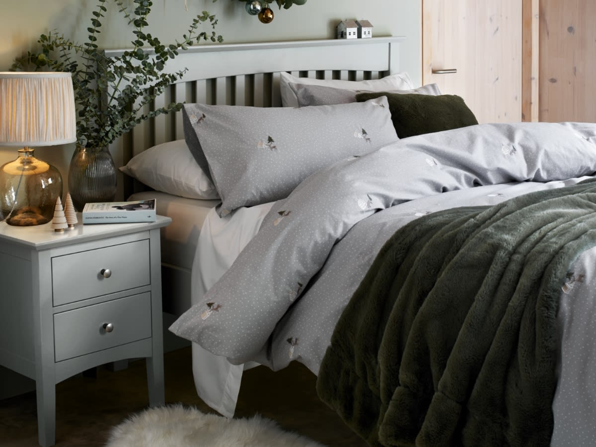 Bee-print bedding on a double bed. Save 10% when you buy a bed and mattress together