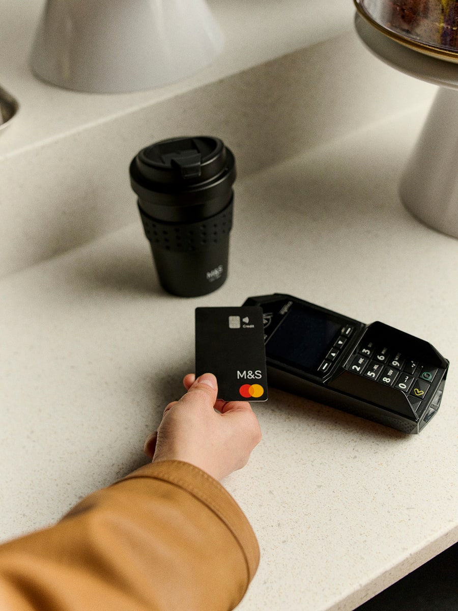 Image showing a hand holding an M&S Credit Card.