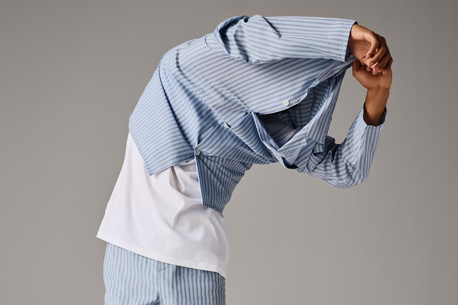 Man wearing blue striped pyjamas and white T-shirt