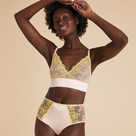 Woman wearing the Blossom embroidered bralette and matching Brazilian knickers