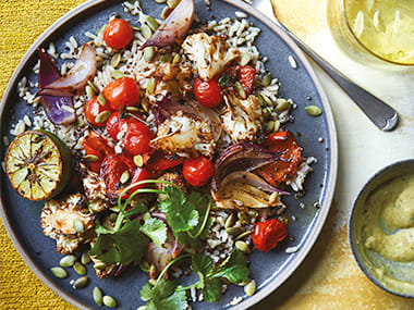 Plate of M&S grain salad on yellow background with fork