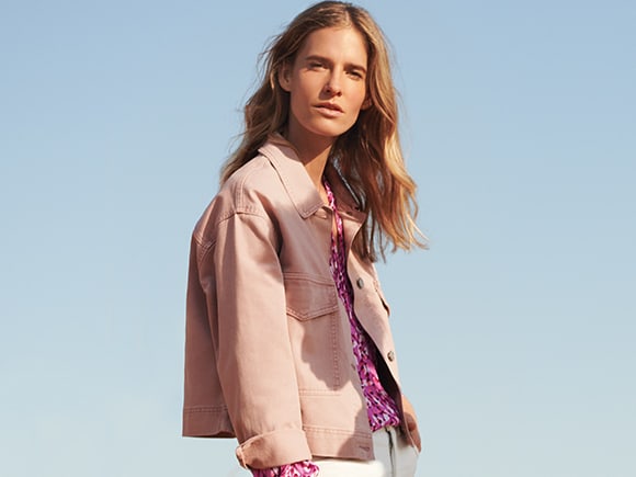 Woman wearing blush-pink denim jacket from Per Una