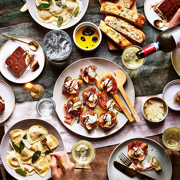An Italian feast of pasta, fig salad, tiramisu and wine