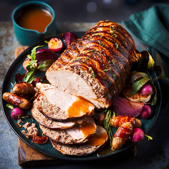 M&S slow cooked turkey joint with bacon stuffing and Collection pigs in blankets on the plate