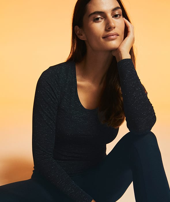 Woman wearing black thermal scoop-neck top and thermal leggings