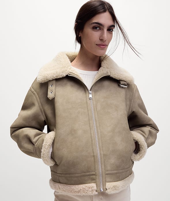 Woman in natural-coloured faux shearling coat