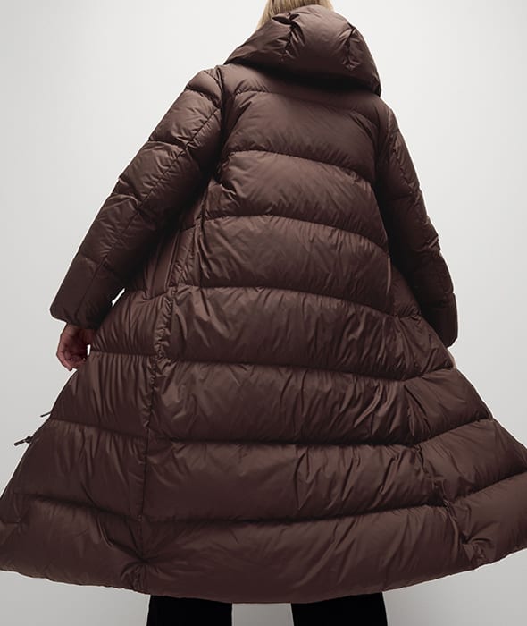 Woman in brown longline puffer coat 