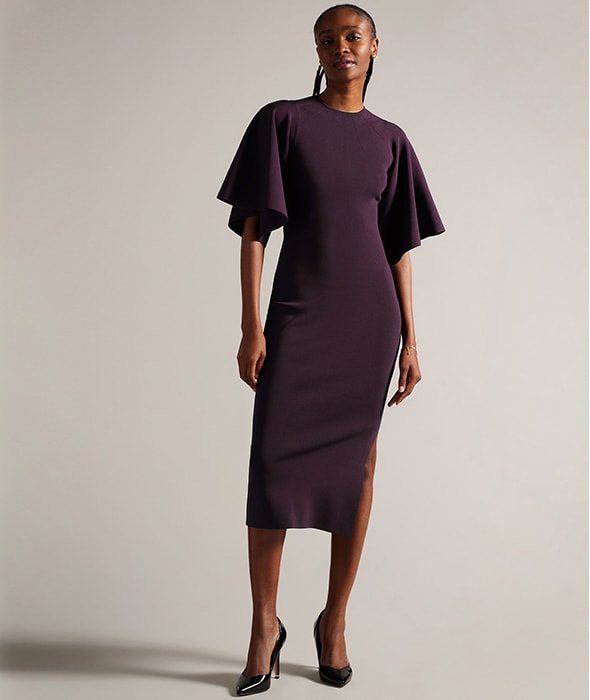 Woman wearing purple Ted Baker dress at M&S
