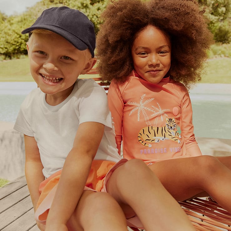 Kids wearing summer holiday clothing. Shop the collection