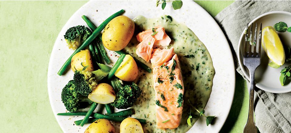 Salmon in a white sauce with new potatoes, green beans and broccoli 