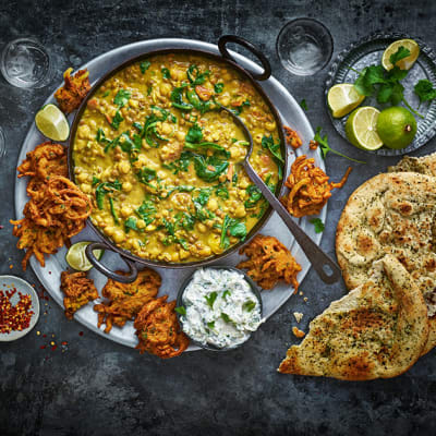 Clodagh McKenna's chickpea and coconut dahl with curried onion bhajis, raita and garlic and coriander naan