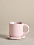 Taza con burbujas y posavasos 