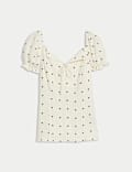 Top à manches bouffantes et motif pois à nouer sur le devant