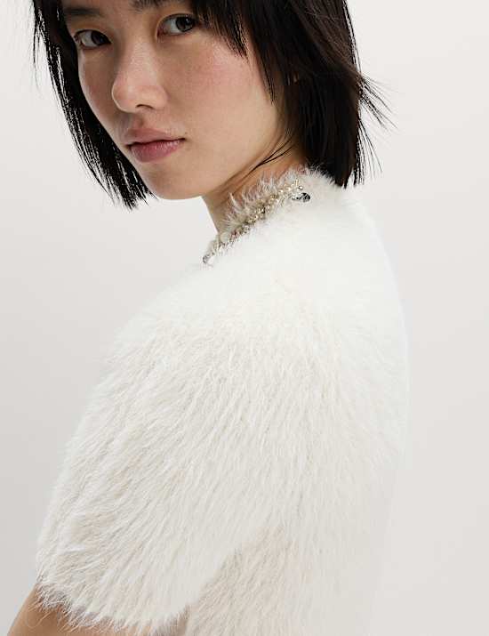 Πλεκτό εφαρμοστό τοπ με κλειστή στρογγυλή λαιμόκοψη και διακοσμητικές λεπτομέρειες