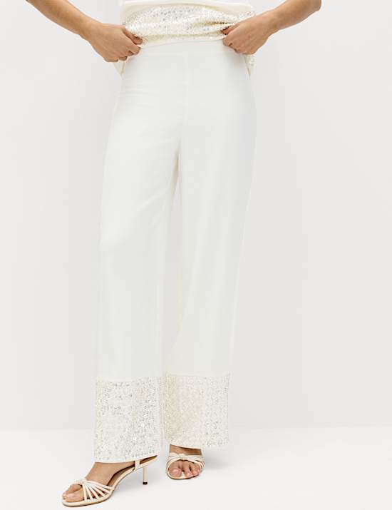 Broek met rechte pijpen versierd met pailletten op de zoom