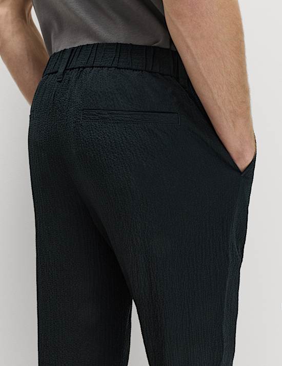 Pantalones tapered de sirsaca de algod&oacute;n