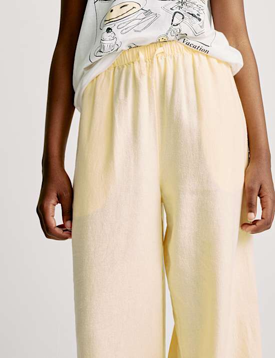 מכנסיים בגזרת רגל רחבה מבד עשיר בפשתן (6-‏16 שנים)