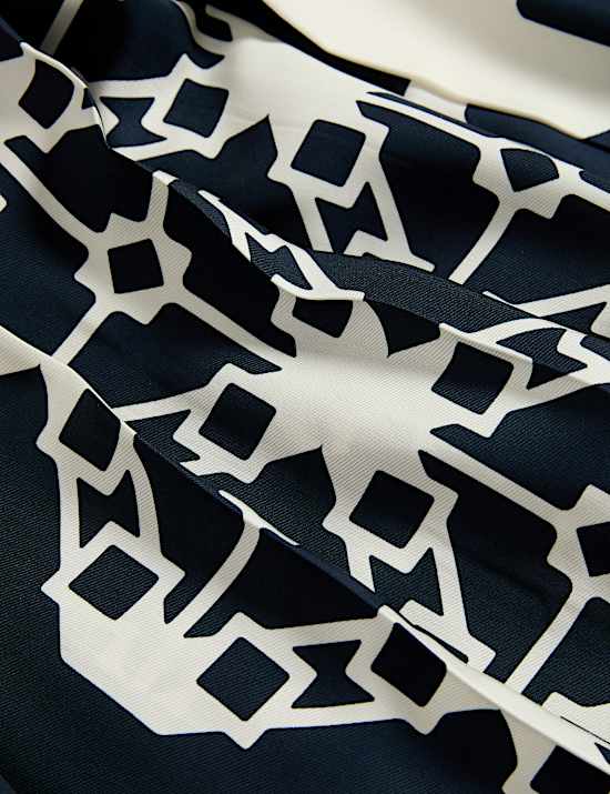 Broekrok van keperstof met wijde pijpen, plooien en print