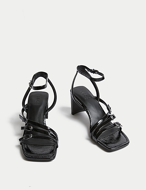 Sk&oacute;rzane sandały z paskami i klamrą na słupku - PL