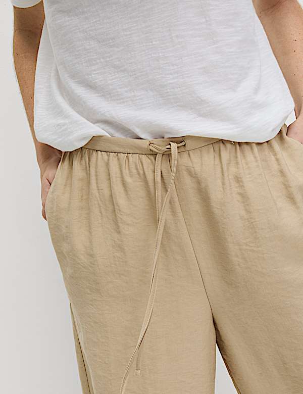 Kortere lyocell-rijke broek met wijde pijpen - NL