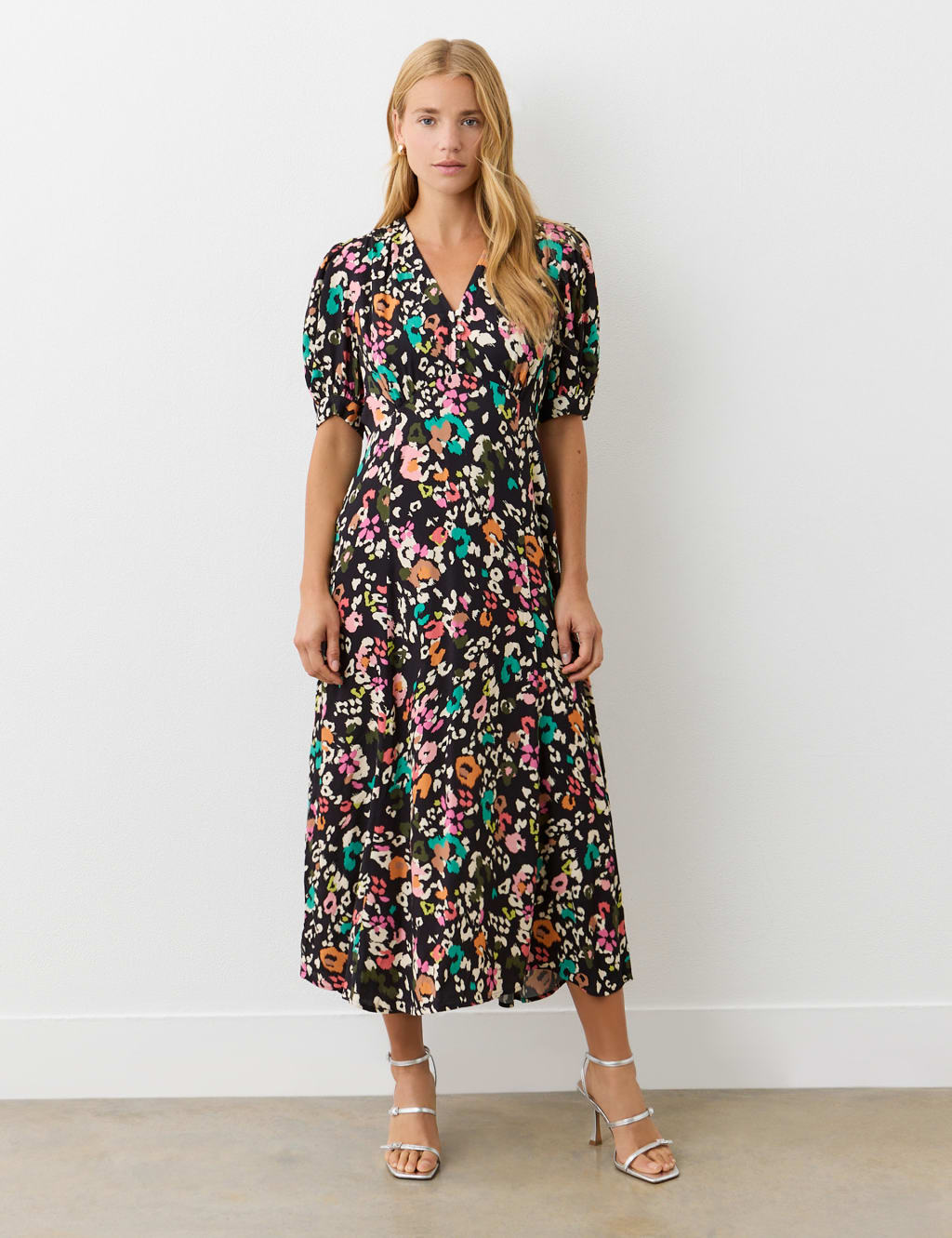 woman wearing black floral midi tea dress